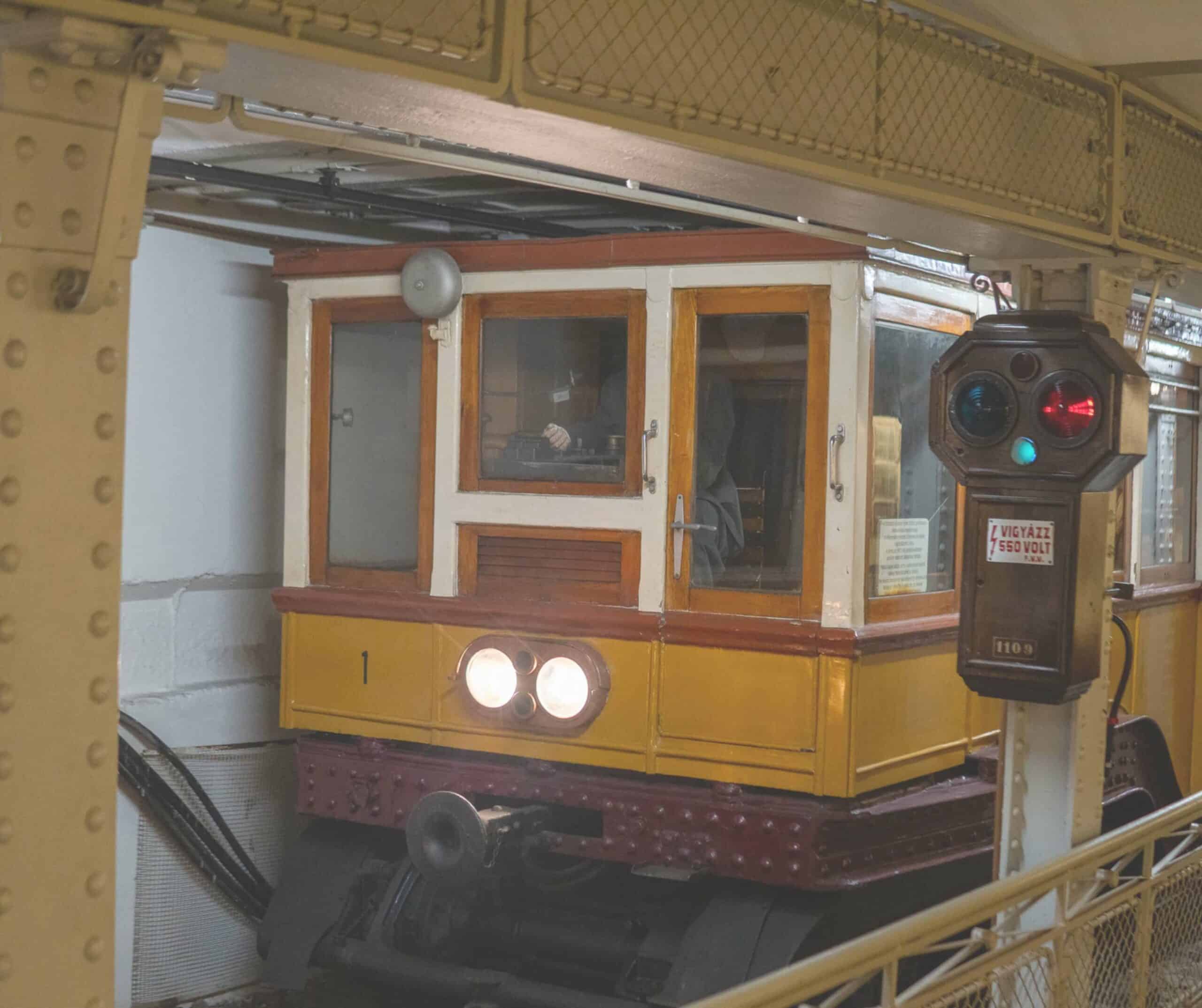 Vintage yellow carriage on display at the Millennium Underground Museum in Budapest