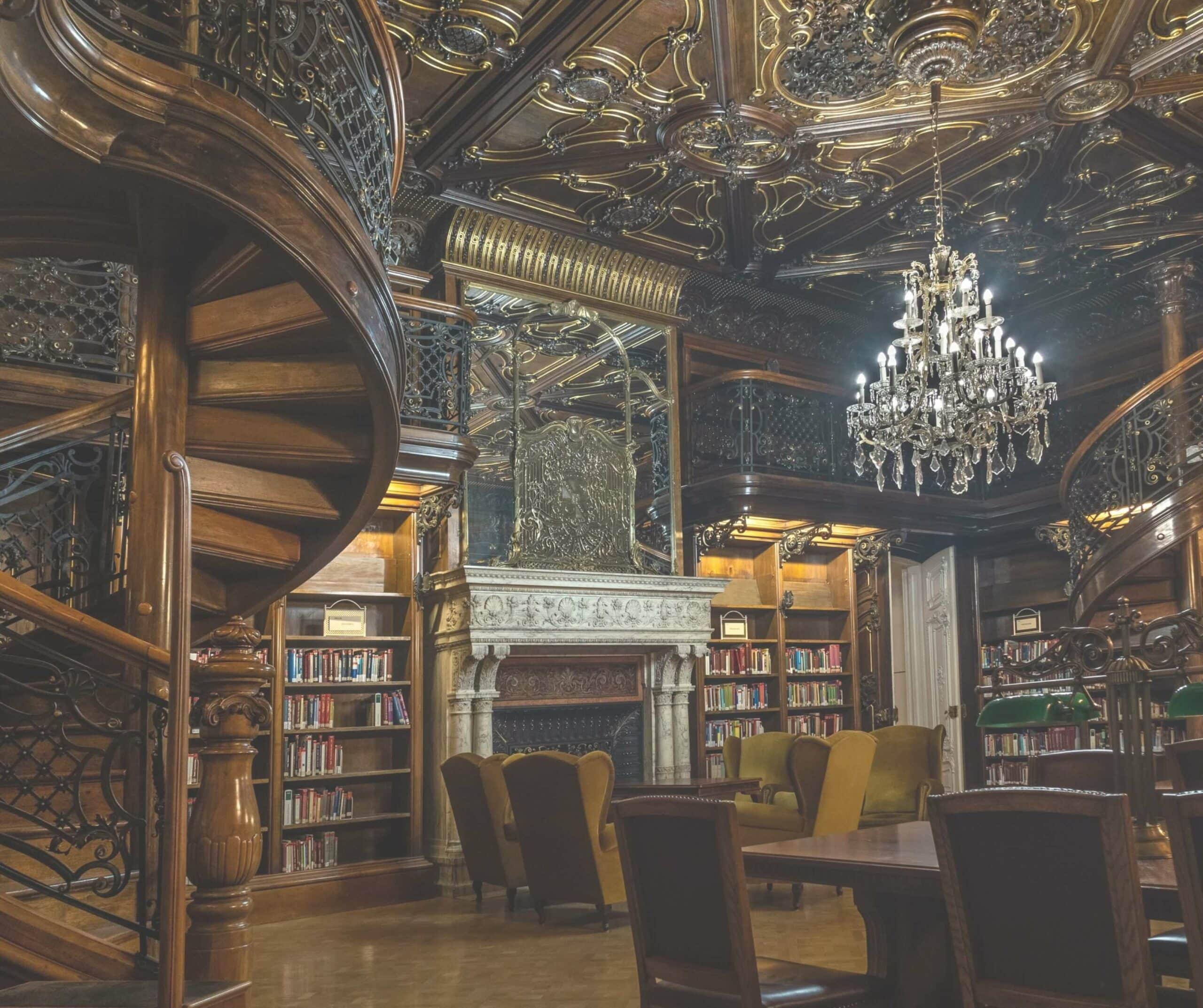 Wooden spiral staircase leading to shelves of old books at the Ervin Szabó Library in Budapest