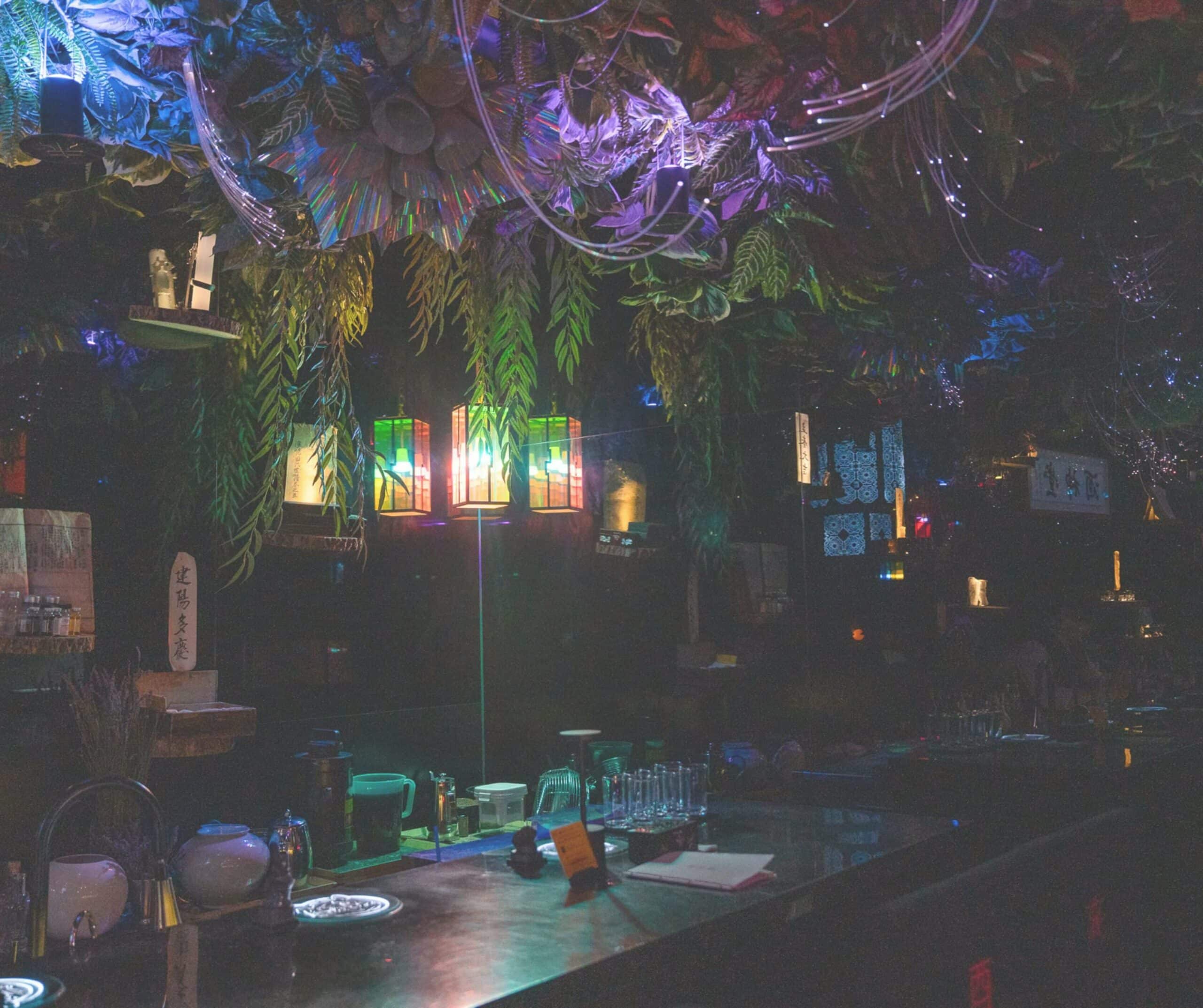 The colorful jungle-themed interior of Zoo Sindang with plants and lanterns