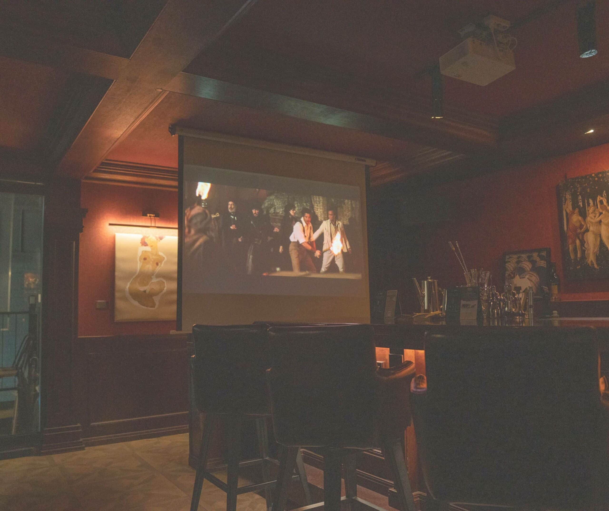 A projector screening a classic film at Bar Catalyst, Yeonnam
