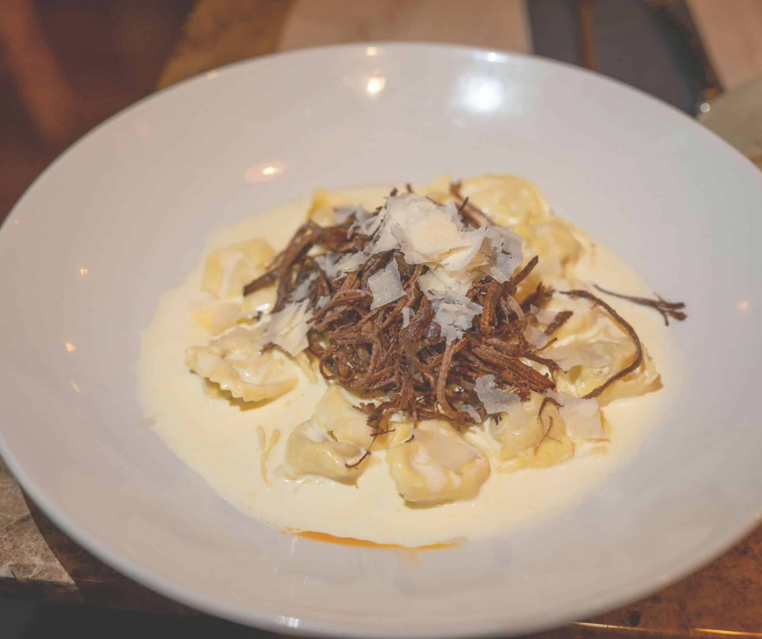 Brisket tortellini in a creamy sauce topped with shredded beef and shaved parmesan at Marco's Mediterranean Kitchen in Rye