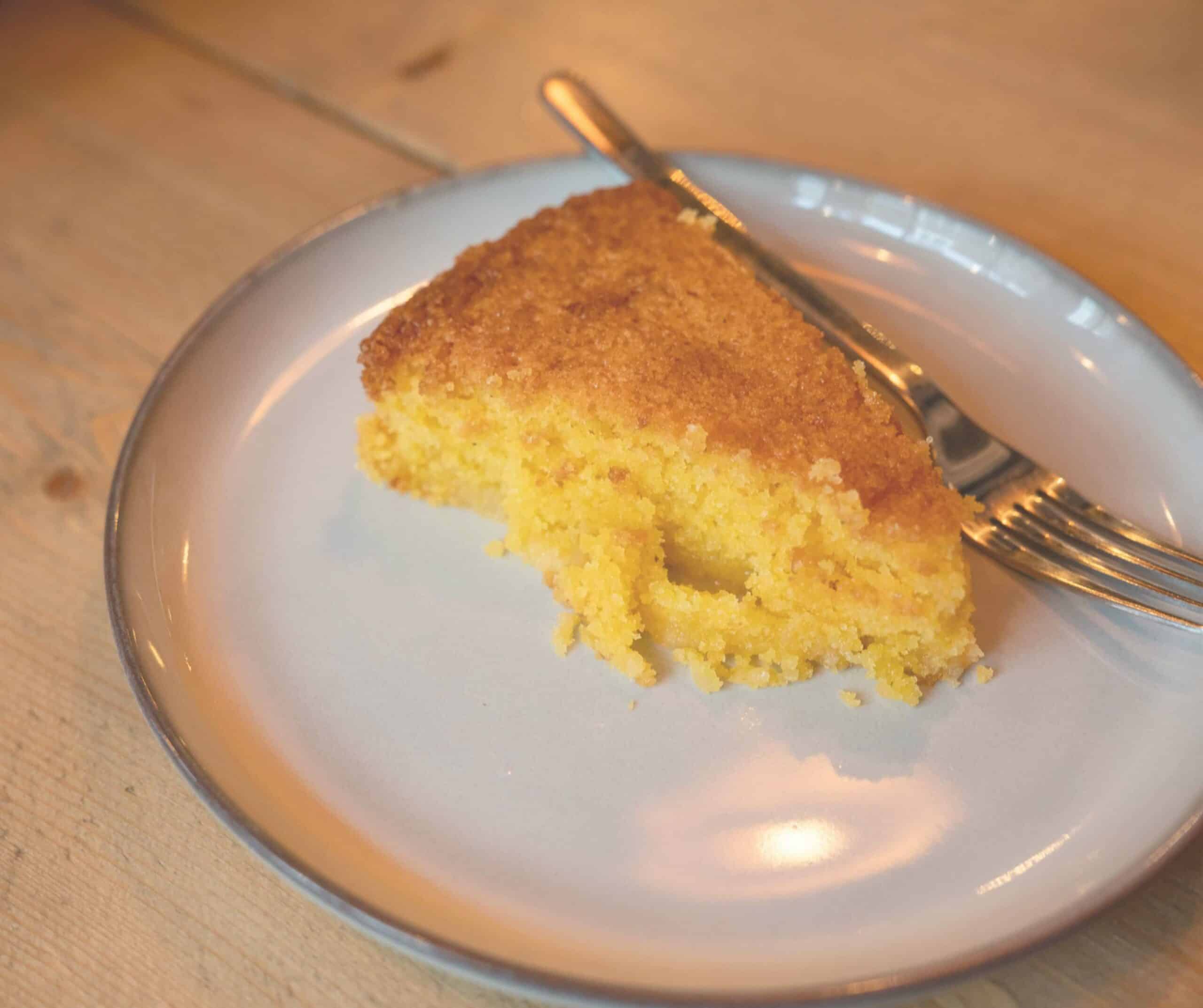 Slice of lemon cake on a plate at Grounded cafe in Rye