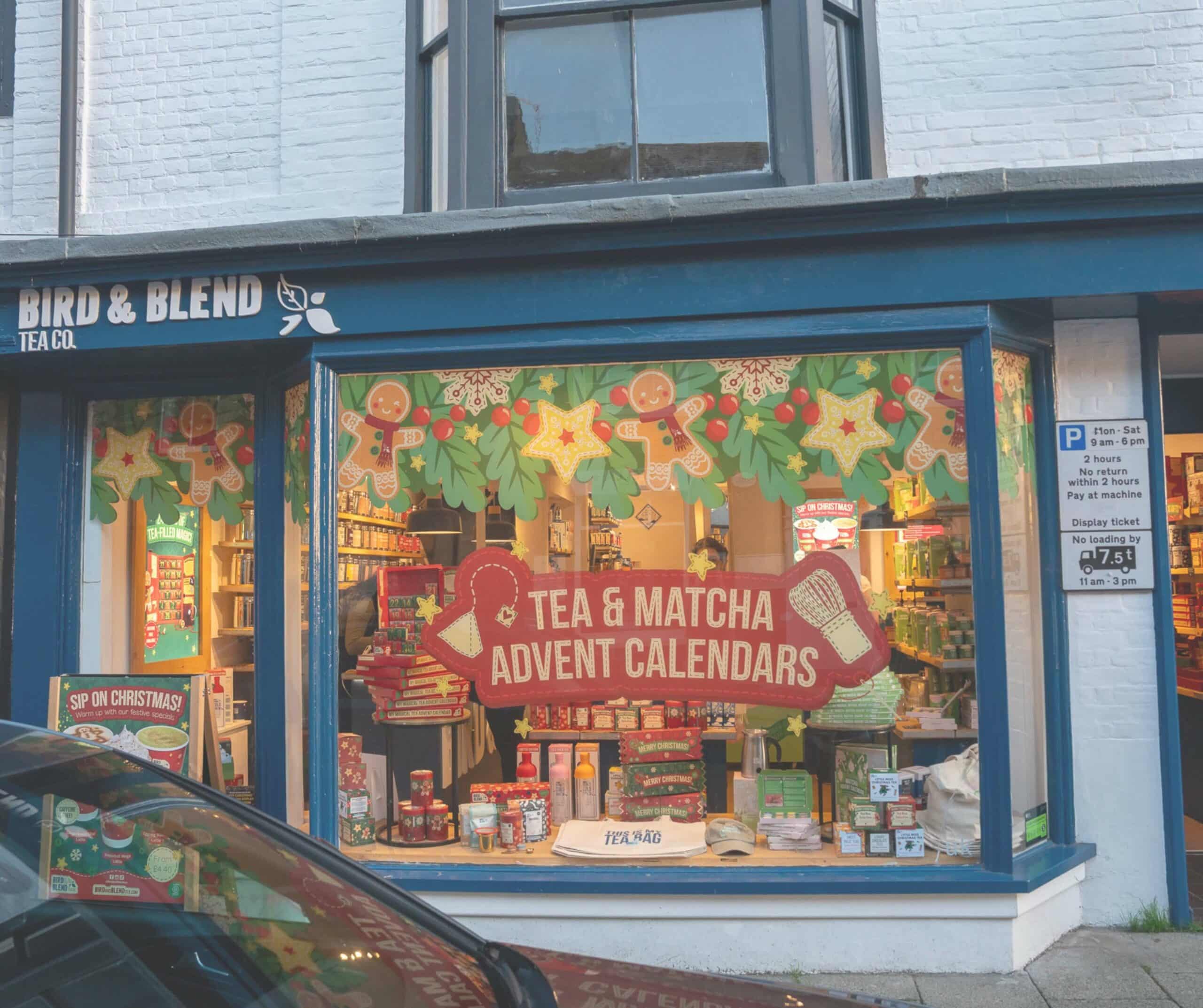 Bird & Blend Tea Co. storefront in Rye with a blue facade and a festive window display of tea and matcha advent calendars