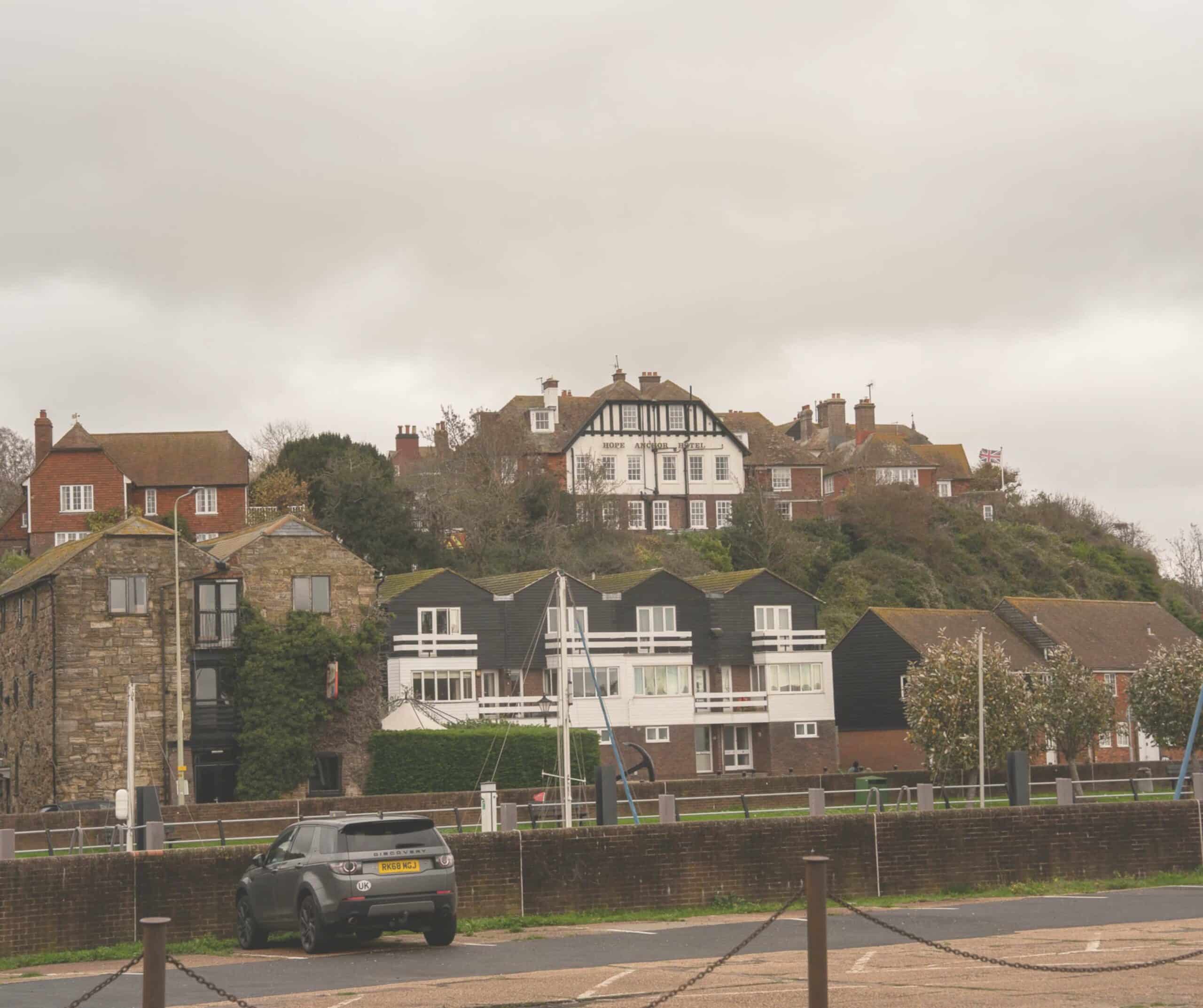 The Hope Anchor Hotel in Rye sitting high above the quayside, viewed across the harbor with the Union Jack flying