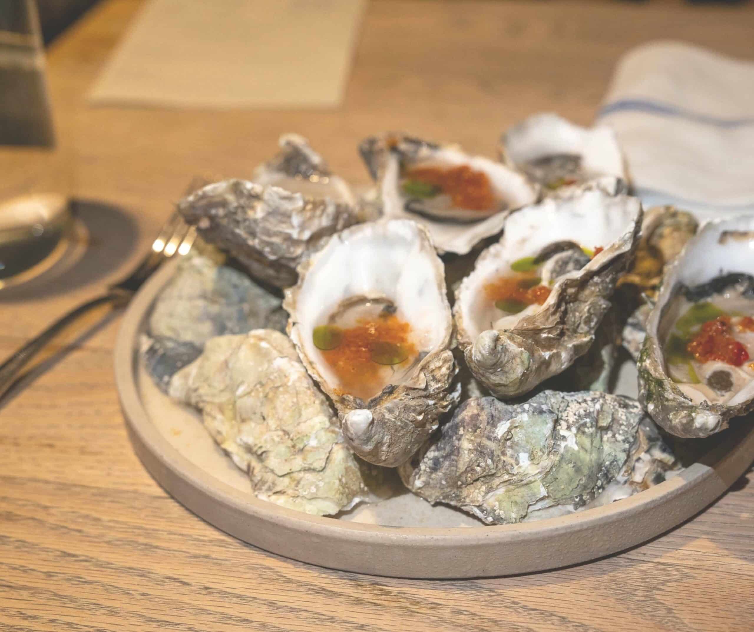 Colchester oysters with jalapeño relish on a ceramic plate at The Union in Rye
