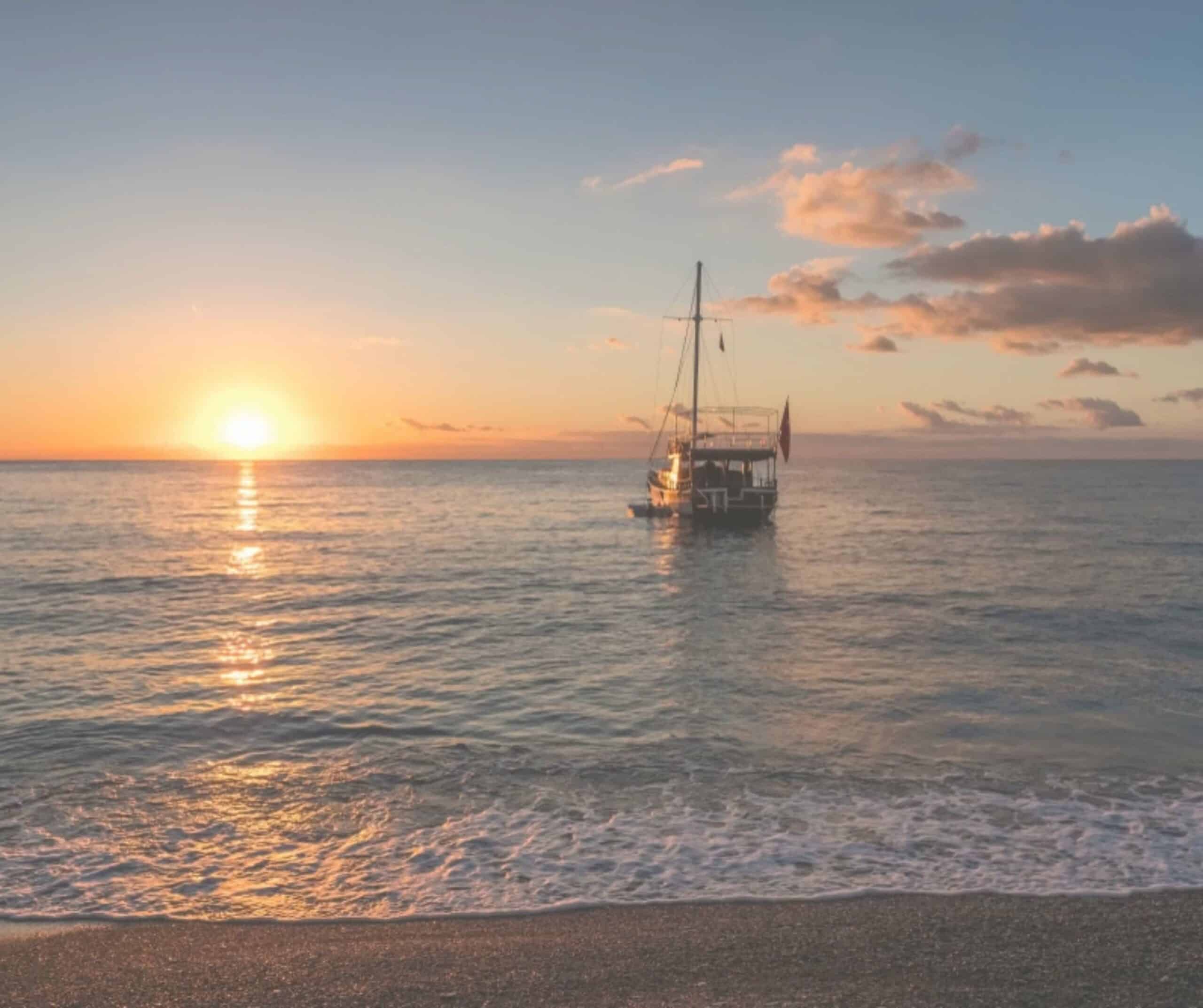 Traditional wooden gulet anchored offshore at sunset, the type of boat used on this Fuerteventura sunset cruise