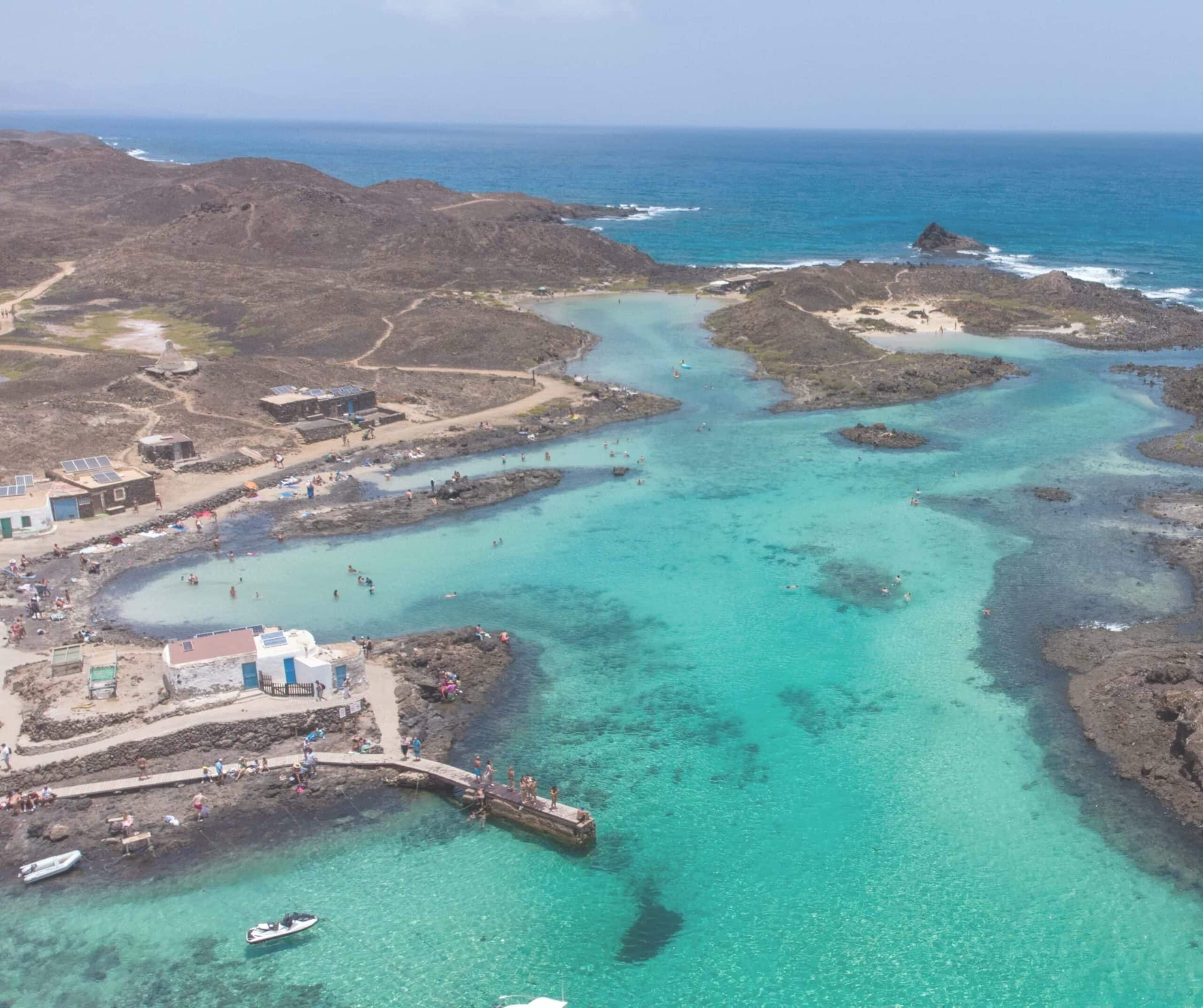 Aerial view of swimmers in the turquoise lagoon at El Puertito on Lobos Island, Fuerteventura