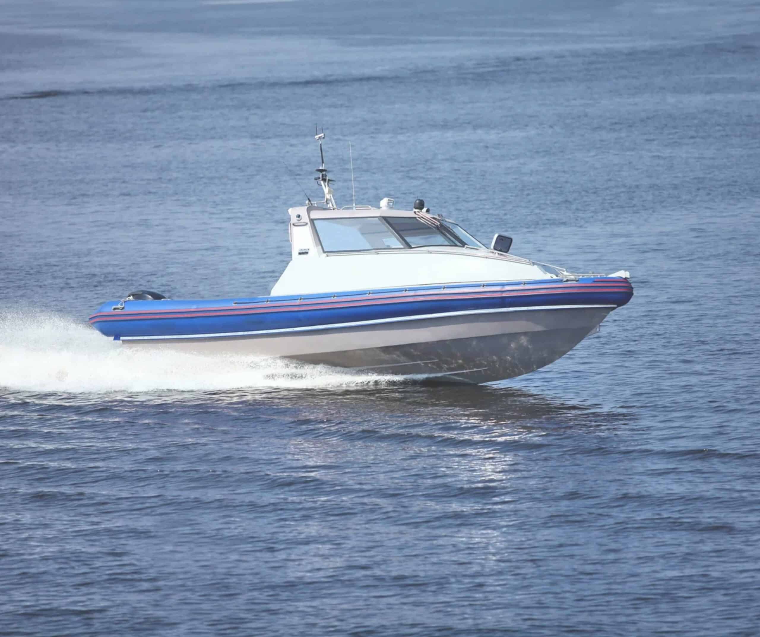 Blue and white speedboat cruising fast across open water, like the boats on small-group Lobos Island speedboat trips